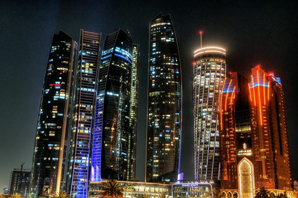 Abu Dhabi skyline at night showing modern towers for investors looking to invest in Abu Dhabi